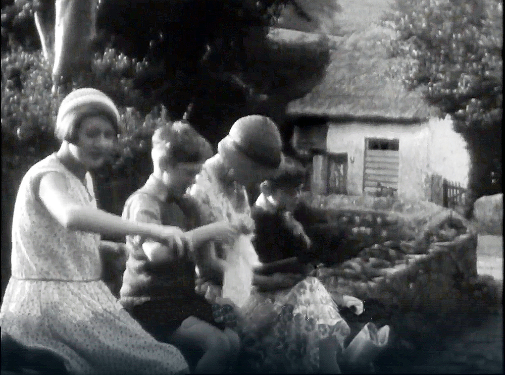 4 children sitting on the low wall leading to the bridge near the Rectory (Manor House) entrance in Luccombe