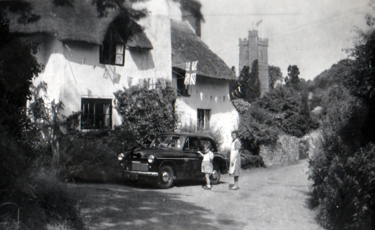 Wychanger Cottage decorated with bunting, with myself, my mother, and our new car